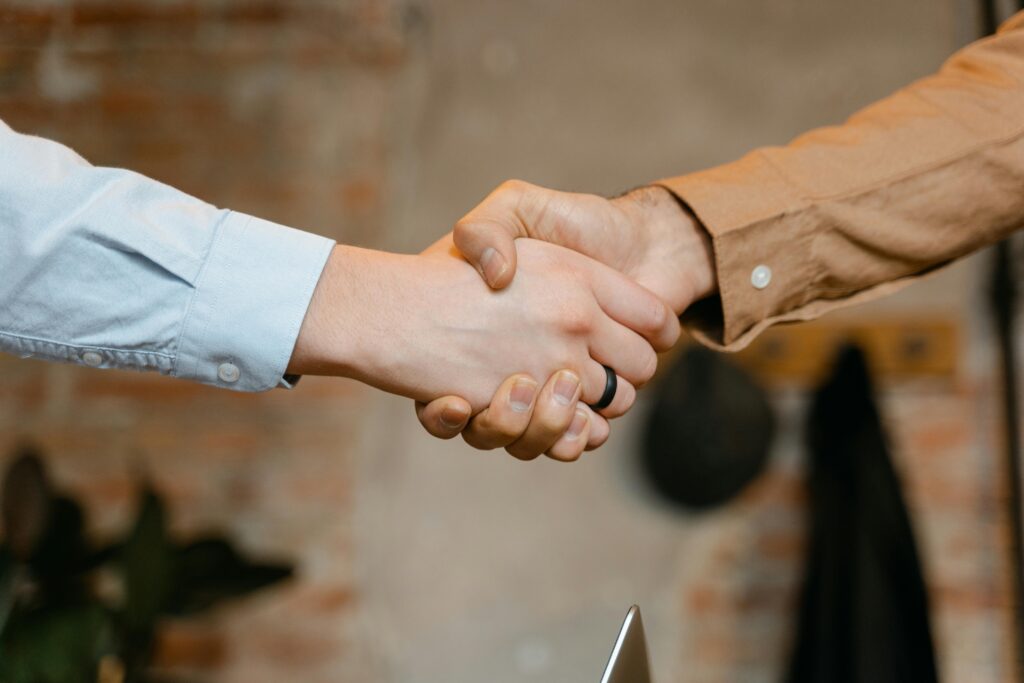 With a handshake