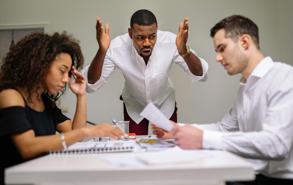 group of 3 people arguing over some documents